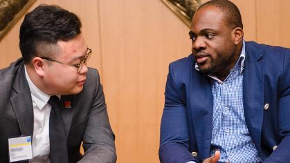 A student and mentor talk in a conference room
